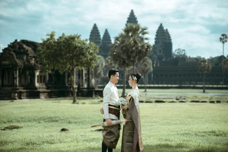 a young couple are standing next to each other