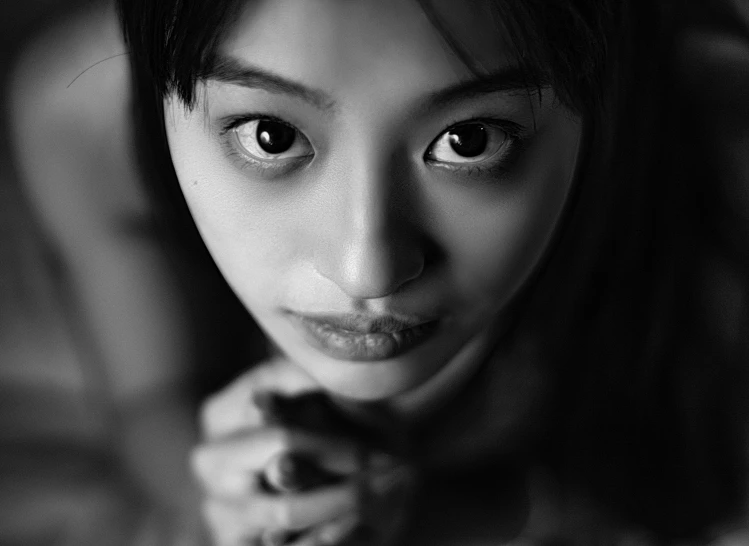 black and white pograph of a woman staring at the camera