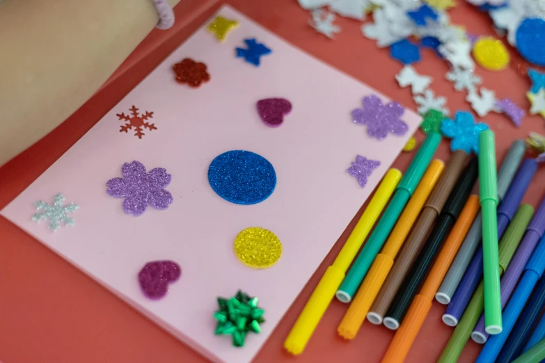 assorted colored crayon markers, some snowflakes and other decorations