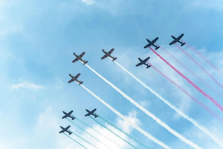 nine jets flying in the sky at an airshow