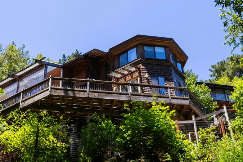 a large house on the side of a hill in a park