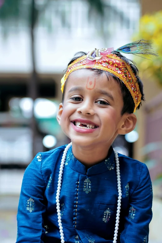 a  wearing beads on top of his head