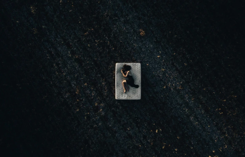 a person on a tiled floor near a wall