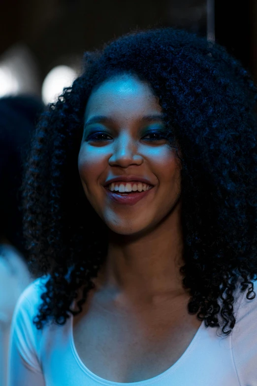 an african american woman smiling with bright light on her