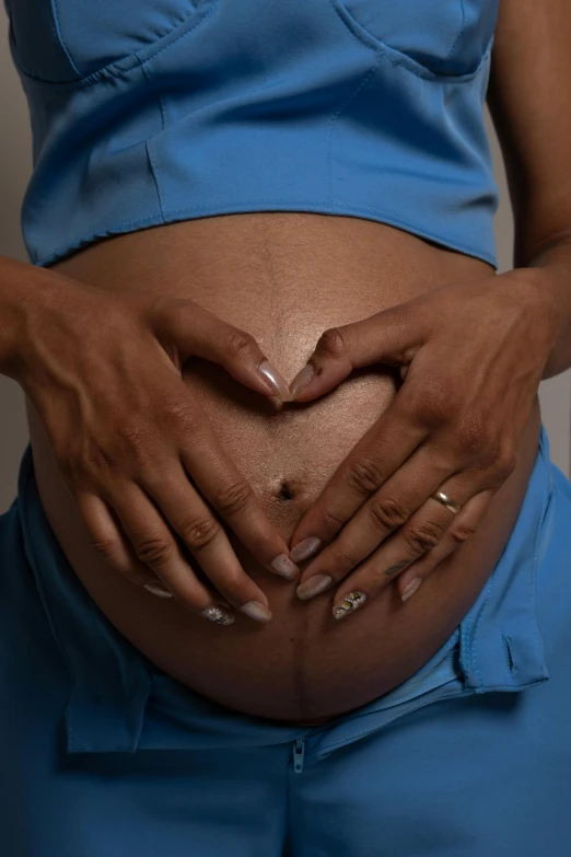 a pregnant woman with her hands on the belly of her belly