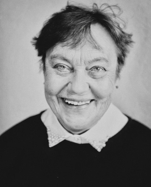 a black and white image of a woman smiling