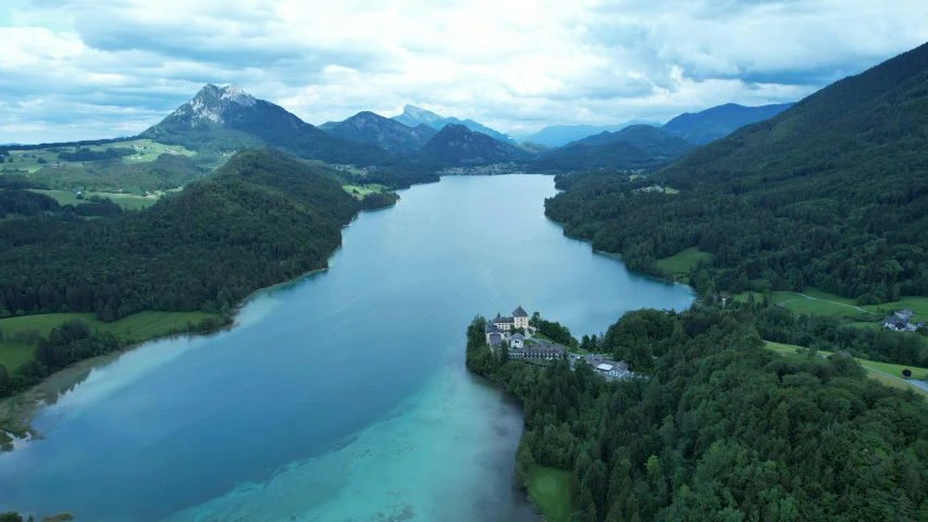 an aerial view of a body of water surrounded by mountains