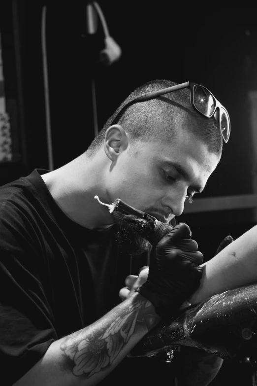 an image of a tattoo artist doing tattoos on his arm