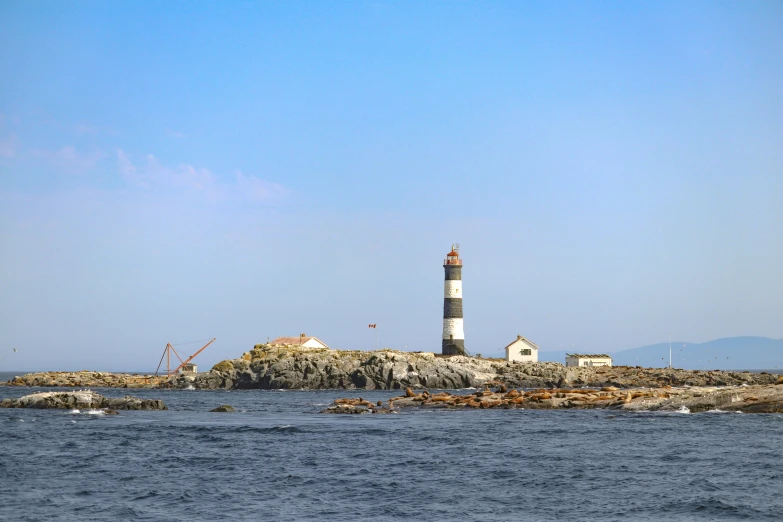 an ocean shore with a light house near it