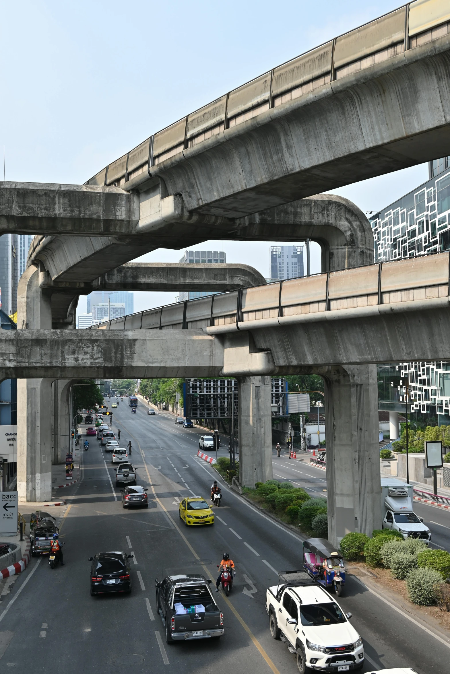 a street scene with cars, buses and trucks