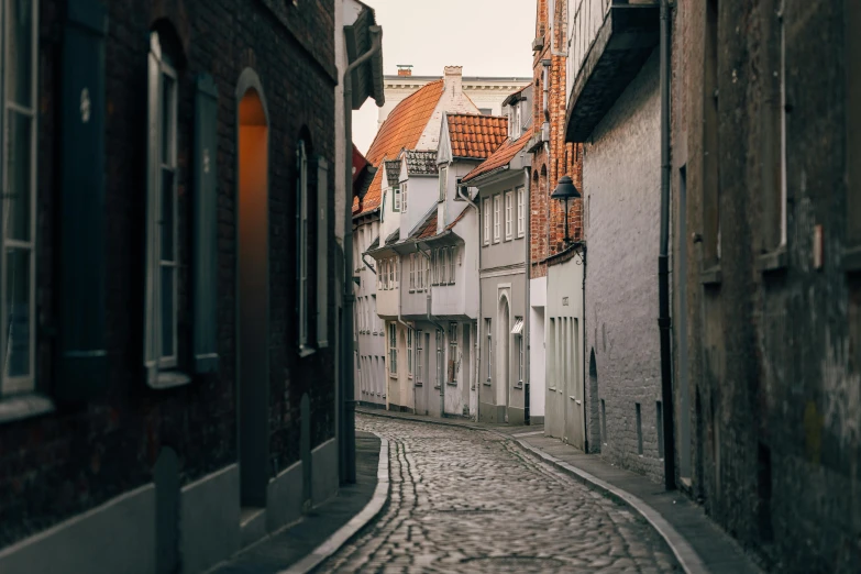 a street lined with tall buildings that have red roofs