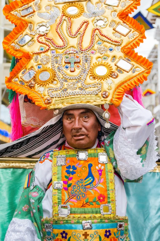 a man dressed in a costume and headdress standing