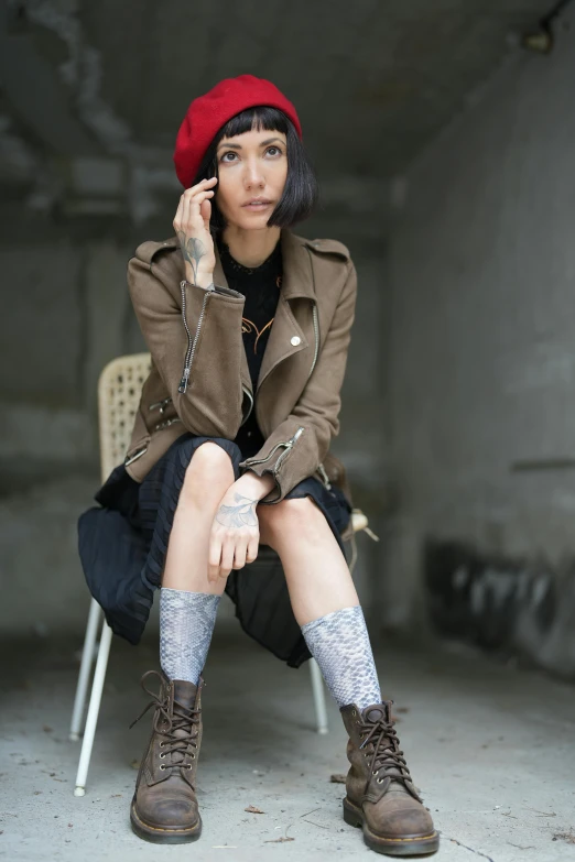 a woman is sitting on a chair and talking on the phone