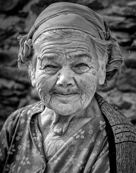 an old woman looks into the camera while smiling