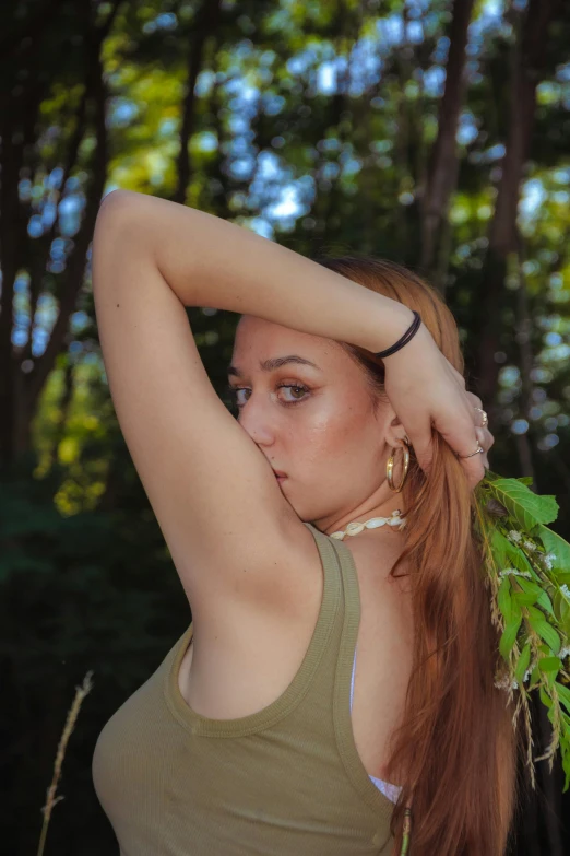 a close up of a person holding her hand near her head