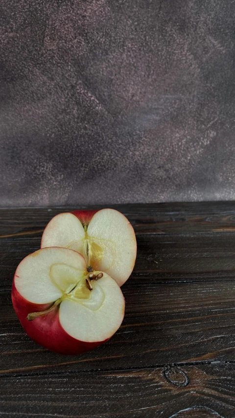 an apple sliced in half sitting on a table