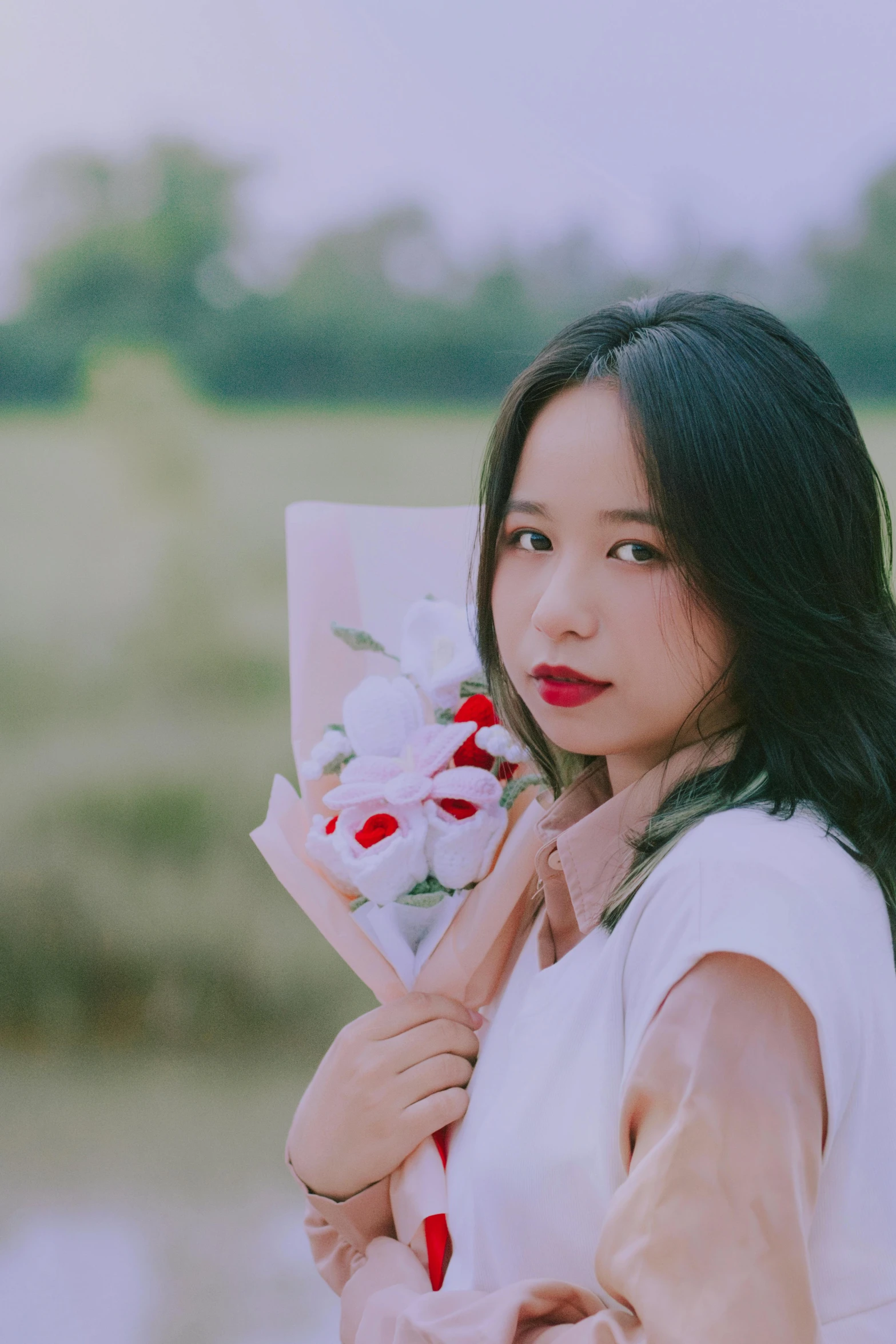 a pretty lady holding some flowers in her hands