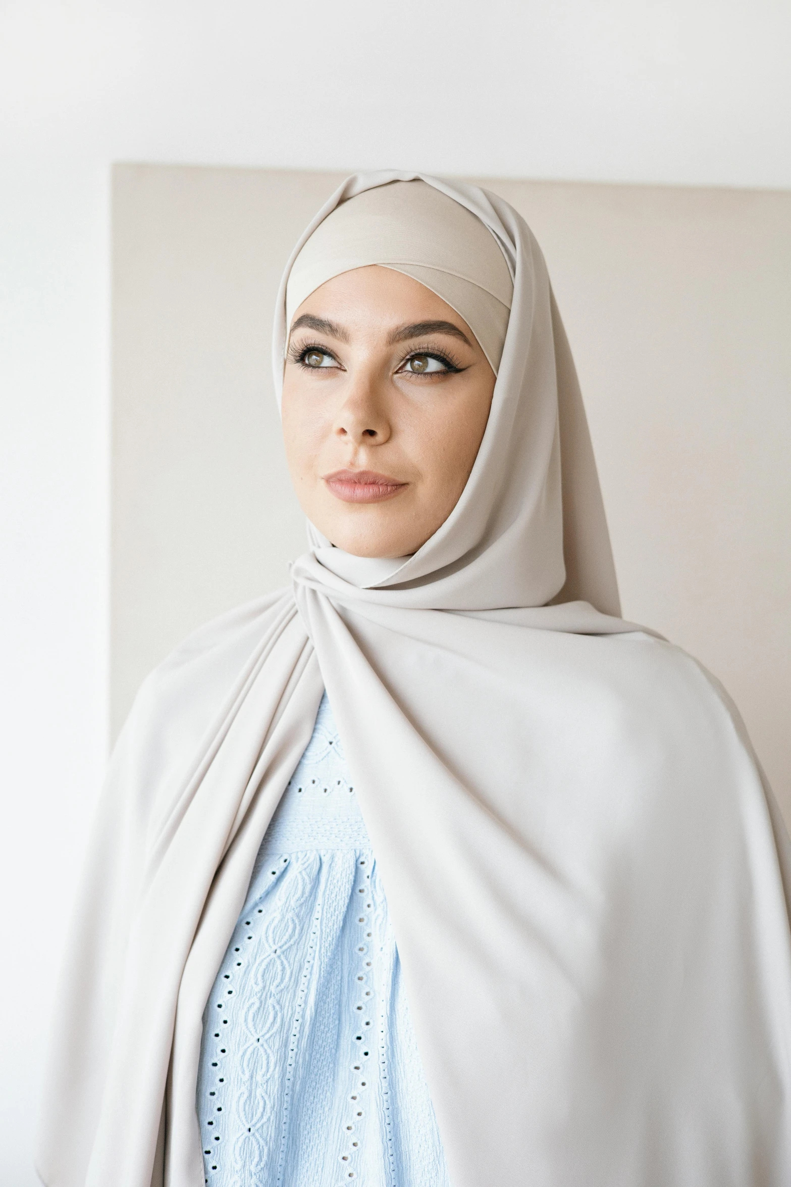 a woman with a hijab is wearing a blanket