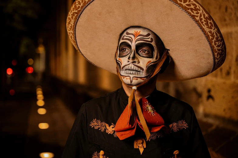 a man wearing a mexican skull mask and sombrero