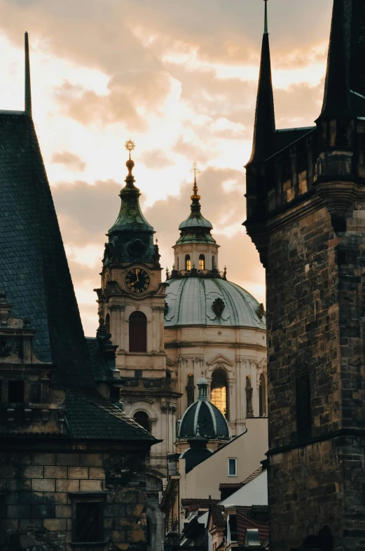 the large building with a steeple and spire has an clock on it