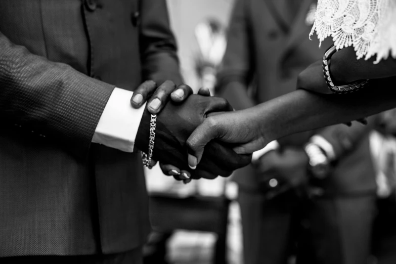 a bride and groom hold hands during their wedding ceremony