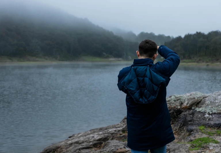 the man is taking pictures on a foggy day