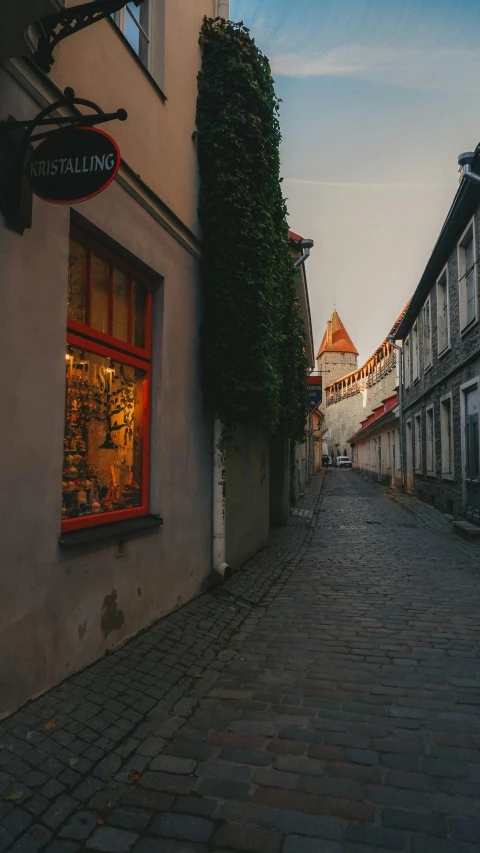 an empty street with a store on the side