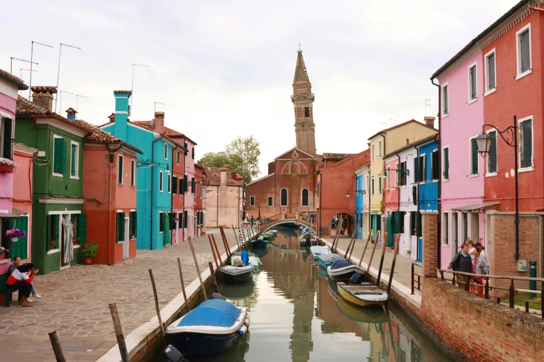 a river with lots of colorful buildings and boats