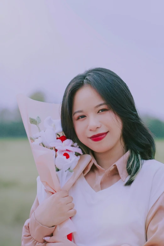 a woman holding an umbrella with flowers in it