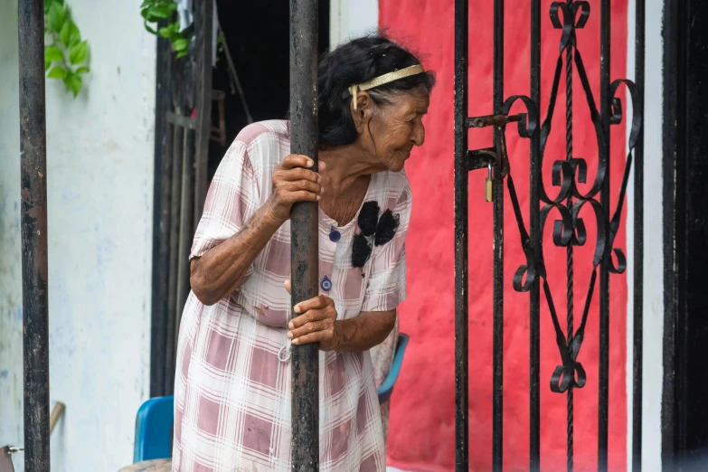 a woman holding a pole near a building