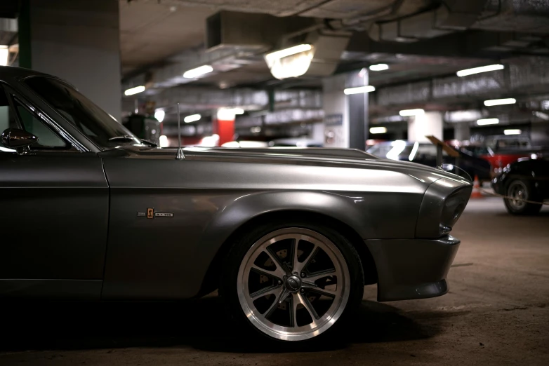 the front of a silver car parked in a garage