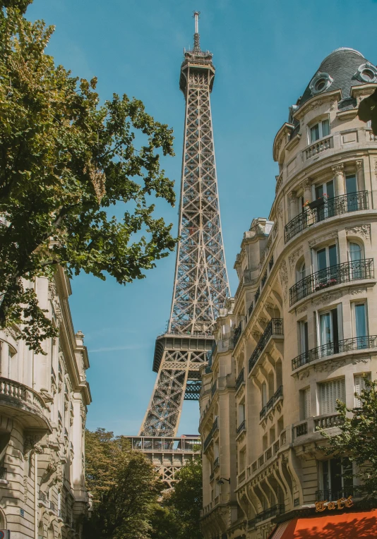 a tall tower stands above a building