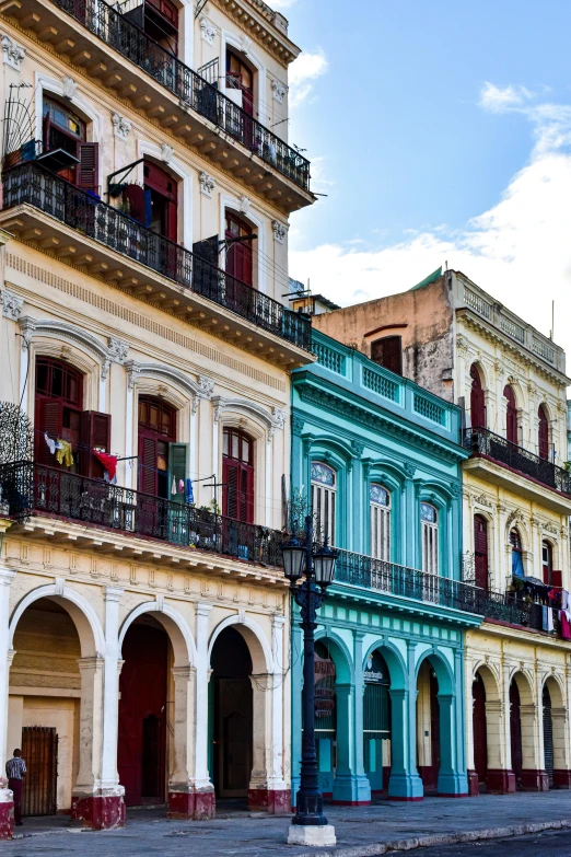 three historic buildings in a city next to one another