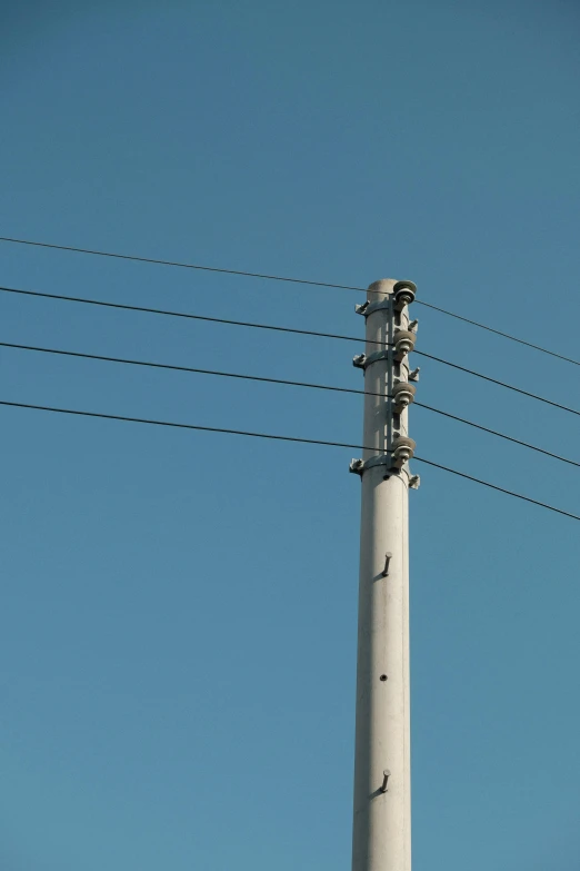 a high tower with some telephone wires on it