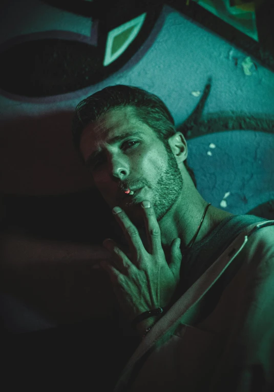 a man smoking on a piece of wood with a blue background