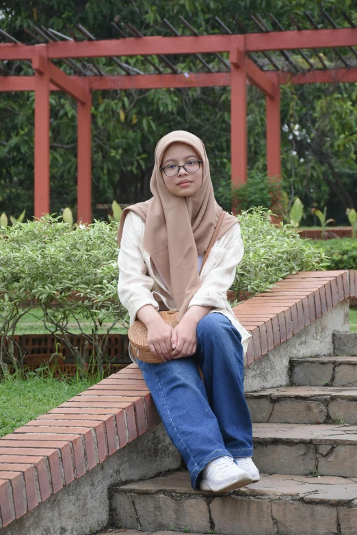 a woman sitting down on some brick steps