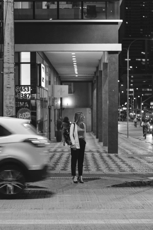 two people talking while standing at the end of a street