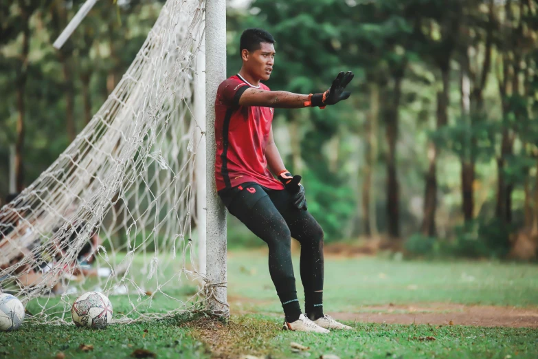 the soccer player is practicing his stance near the goal