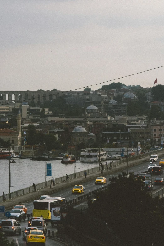 traffic moves along a roadway through a town and in the water