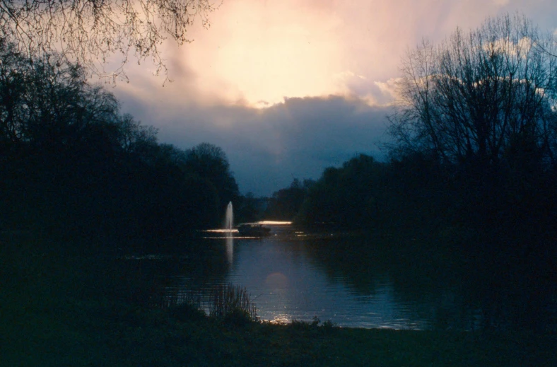 an image of a river with trees and sky