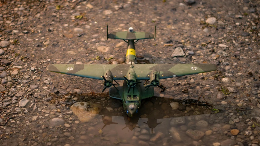 an old plane sitting in some muddy water