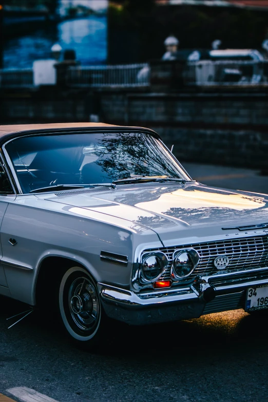 a classic car parked along the side of the road