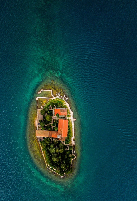 an island in the middle of a blue ocean