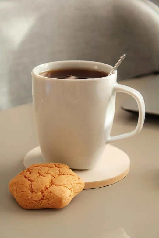 there is a cookie and a cup of coffee