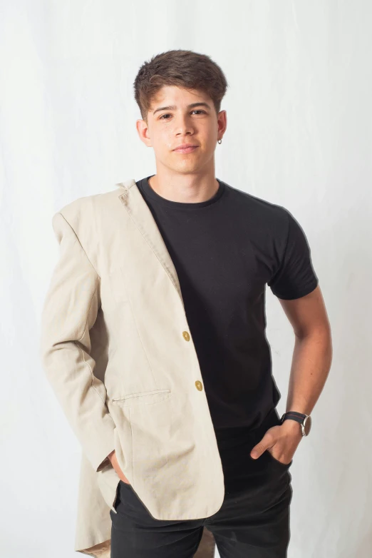 a young man with short hair and a jacket over his shoulder