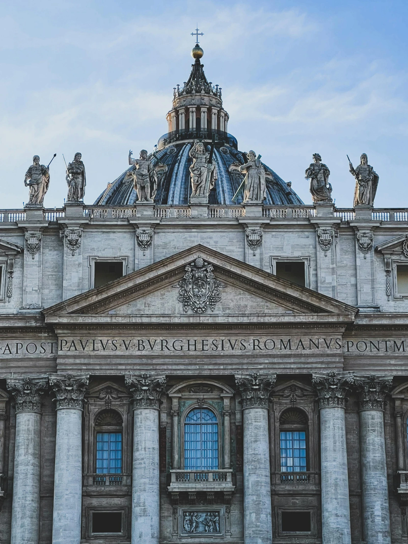 a very nice looking building with statues around it