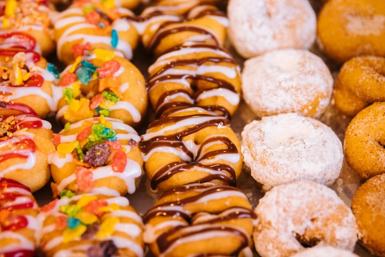 a close up of many different types of donuts