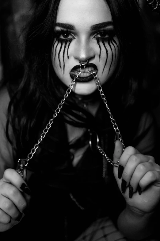 a woman wearing a face chain and gag