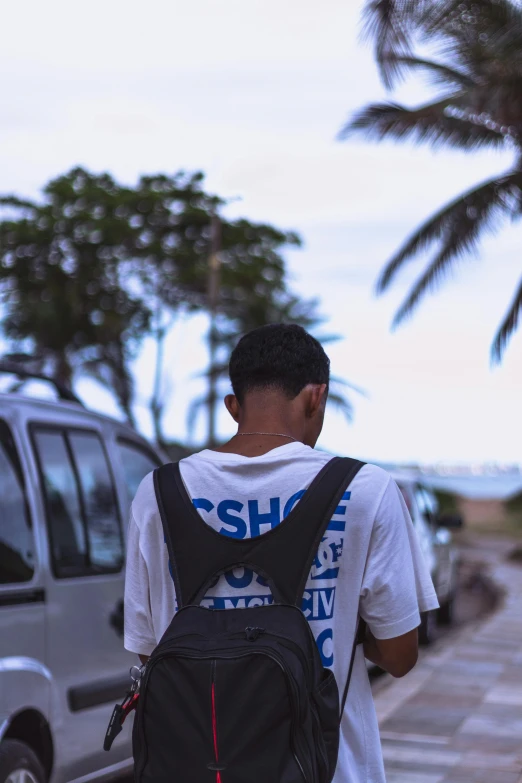 a man carrying a backpack across a street