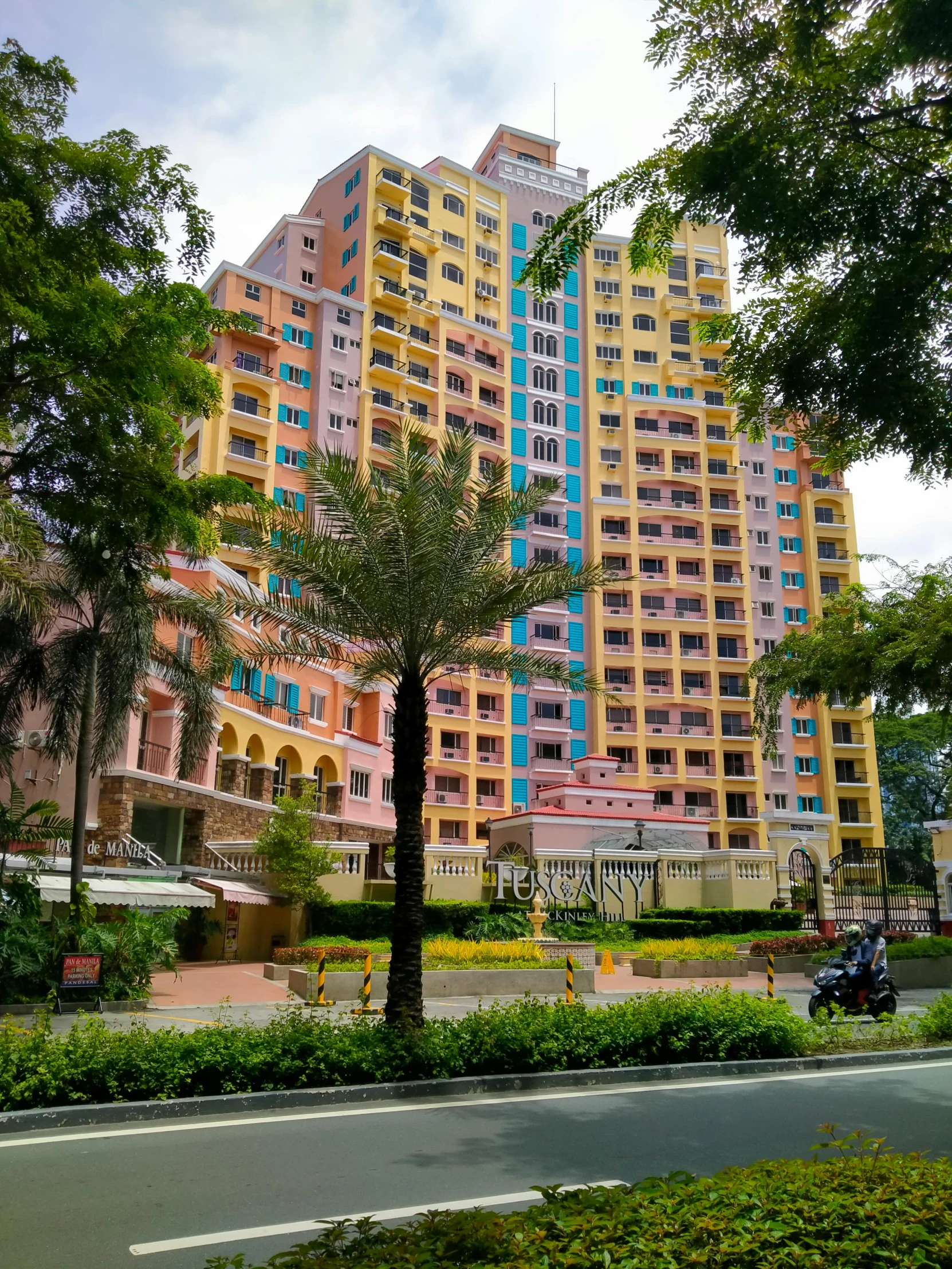 a large building with colorful, tall buildings in the background